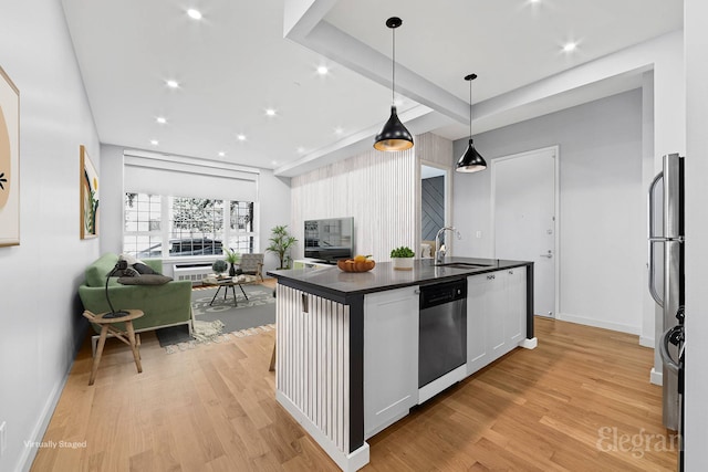 226 15th St Unit 1A, New York City, NY 11215 - kitchen with stainless steel dishwasher, dark countertops, a sink, open floor plan, and light wood-style floors
