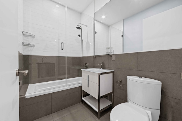 226 15th St Unit 1A, New York City, NY 11215 - full bath with tiled shower / bath combo, toilet, vanity, tile patterned flooring, and tile walls