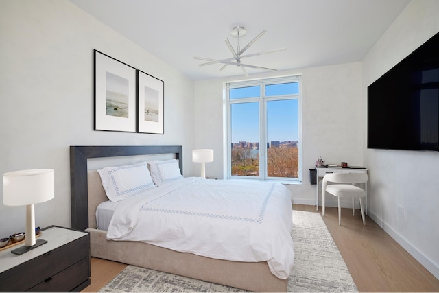 bedroom featuring light wood-style flooring and baseboards