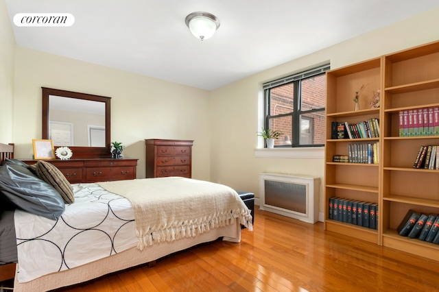 bedroom with visible vents and wood finished floors