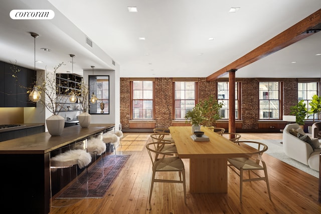 30 Crosby St Unit 4A, New York City, NY 10013 - living area featuring brick wall, decorative columns, hardwood / wood-style floors, and beam ceiling