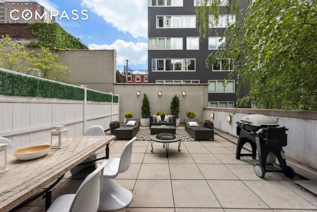 view of patio with an outdoor hangout area and fence