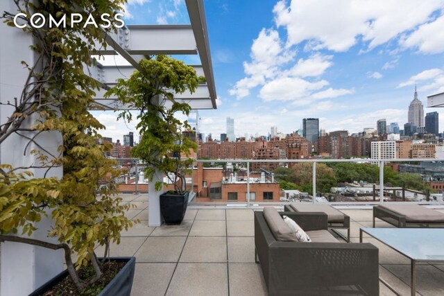 view of patio / terrace with a skyline view, a balcony, and outdoor lounge area