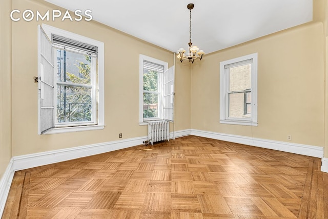 576 5th St Unit B2, New York City, NY 11215 - spare room with radiator heating unit, a chandelier, and baseboards