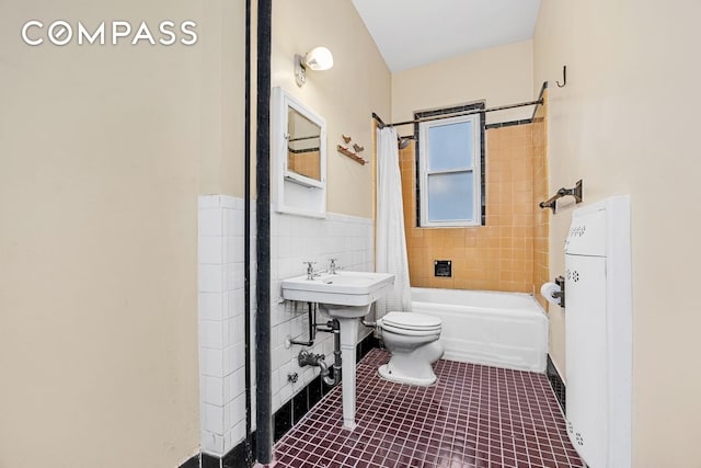 576 5th St Unit B2, New York City, NY 11215 - full bathroom featuring toilet, tile patterned floors, tile walls, shower / bath combo, and wainscoting