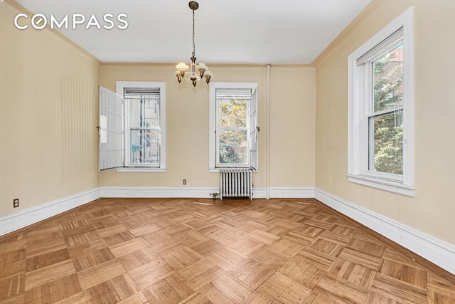 576 5th St Unit B2, New York City, NY 11215 - empty room featuring radiator heating unit, a chandelier, and baseboards