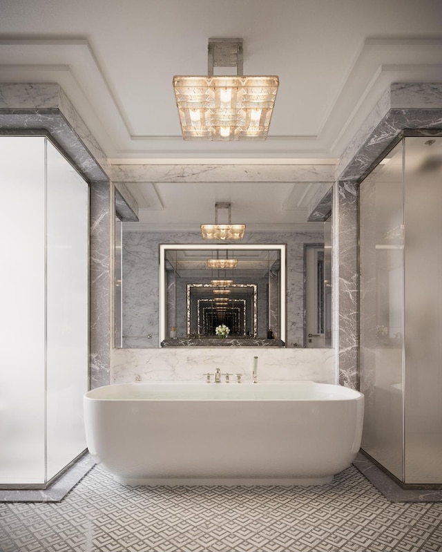 bathroom featuring a chandelier and a freestanding tub