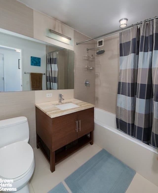 505 W 47th St Unit 5Dn, New York City, NY 10036 - full bath with shower / tub combo with curtain, vanity, tile patterned floors, and tile walls