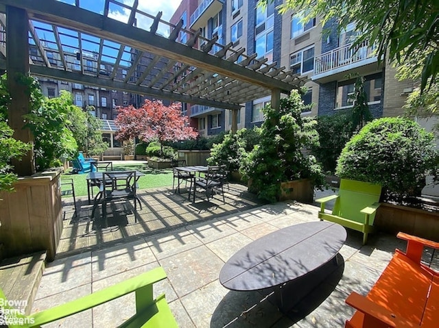 surrounding community featuring outdoor dining area, a pergola, and a patio area