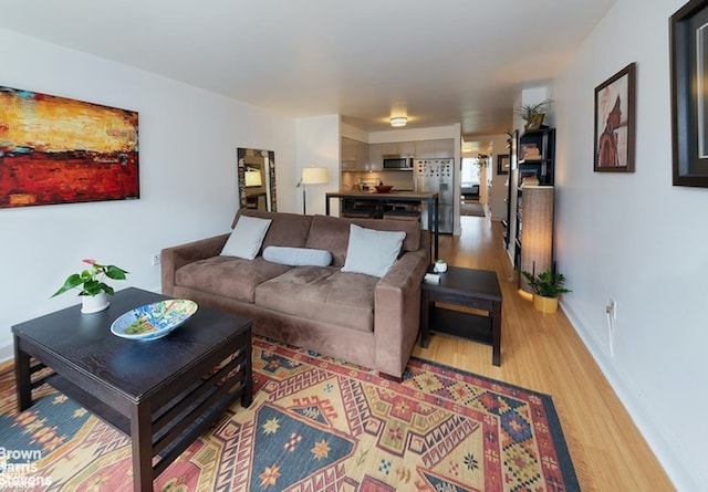 living area with light wood finished floors and baseboards