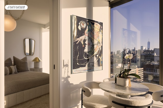 hallway featuring a view of city and carpet