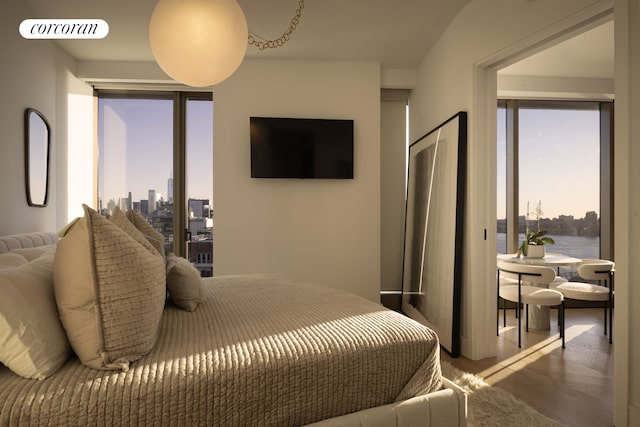 bedroom featuring wood finished floors and visible vents