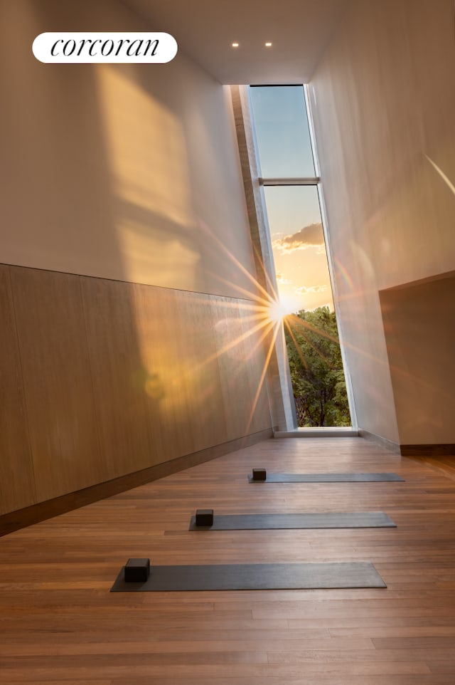 stairs featuring wood finished floors and floor to ceiling windows