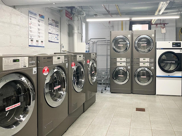 community laundry room with stacked washer / dryer and washer and clothes dryer
