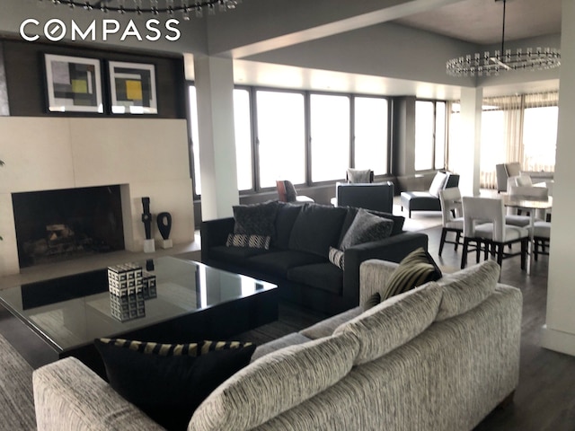 living area featuring a premium fireplace, wood finished floors, and plenty of natural light