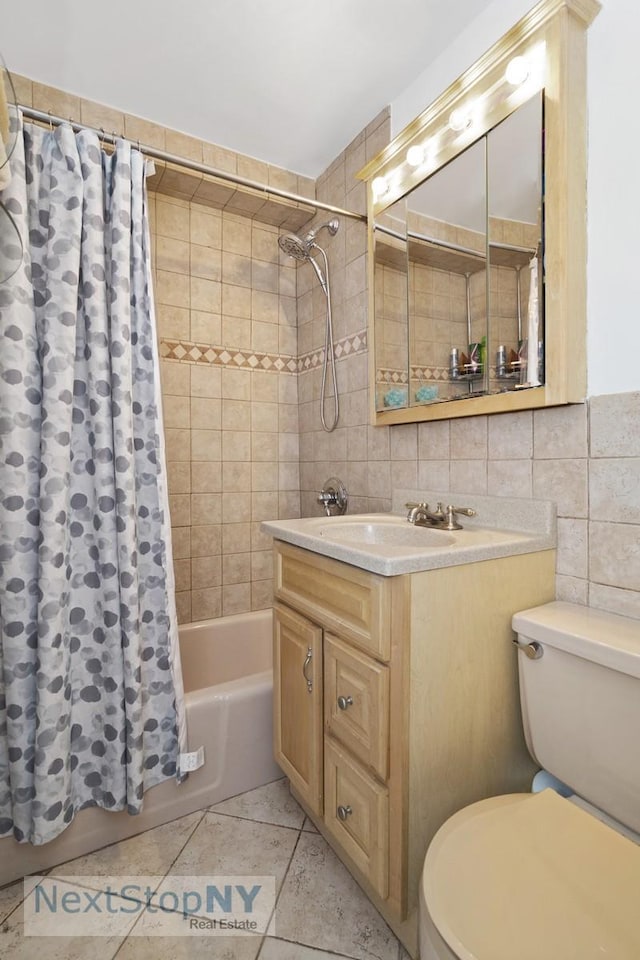 333 E 66th St Unit 7A, New York City, NY 10065 - full bath with tile walls, toilet, tile patterned floors, shower / bath combo, and vanity