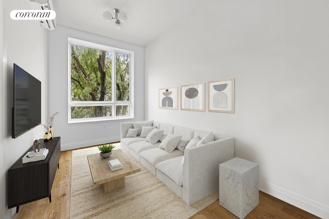 living room with baseboards and wood finished floors