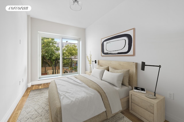 bedroom featuring baseboards and wood finished floors