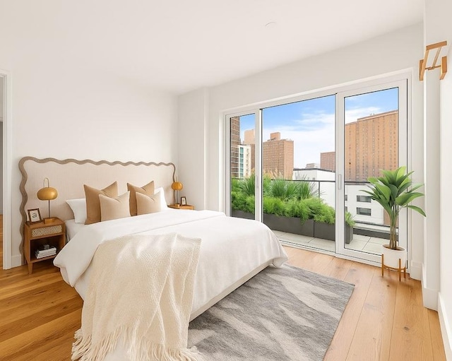 427 E 90th St Unit Ph10, New York City, NY 10128 - bedroom with access to exterior and hardwood / wood-style floors