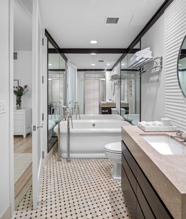 141 5th Ave Unit 3A, New York City, NY 10010 - full bath with a soaking tub, toilet, vanity, tile patterned floors, and recessed lighting