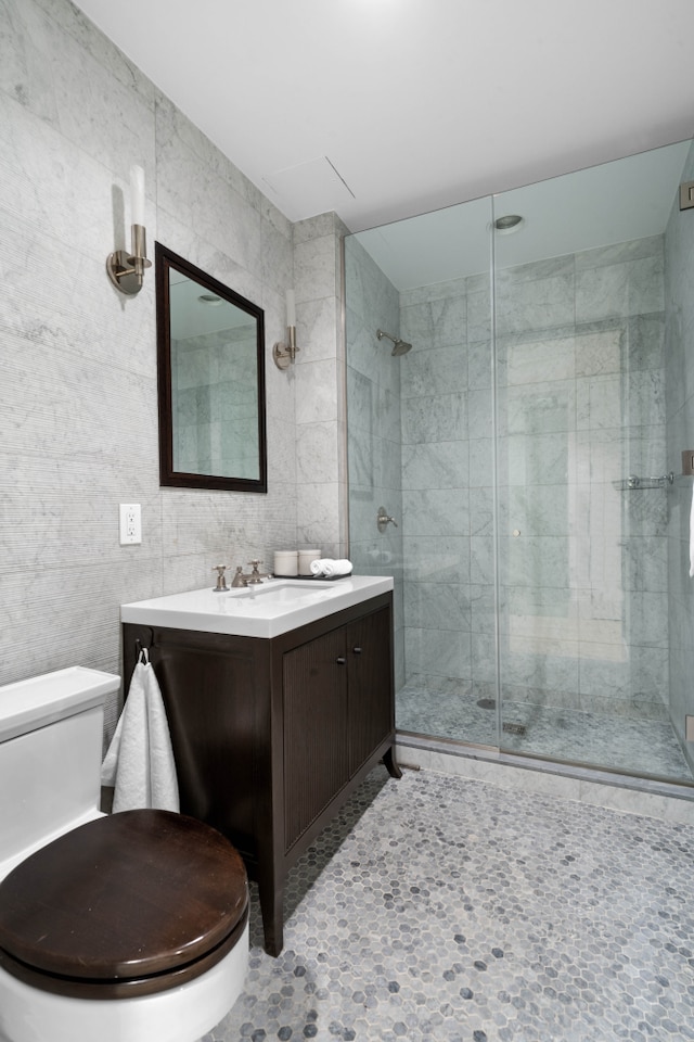 141 5th Ave Unit 3A, New York City, NY 10010 - full bath featuring toilet, vanity, a stall shower, and tile walls