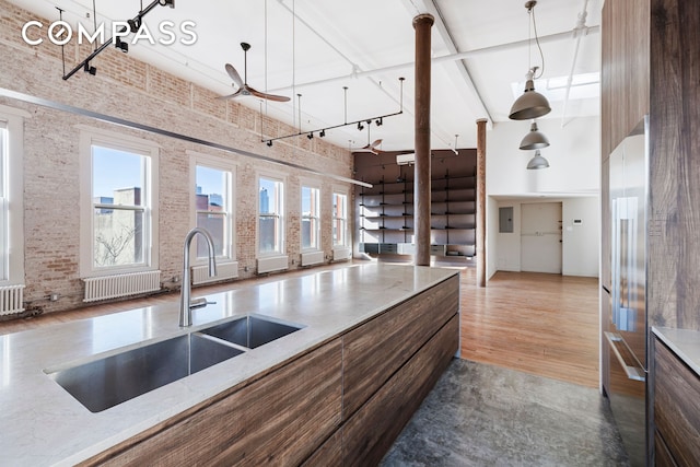 705 Driggs Ave Unit 13, New York City, NY 11211 - kitchen featuring a high ceiling, a sink, wood finished floors, ceiling fan, and decorative light fixtures