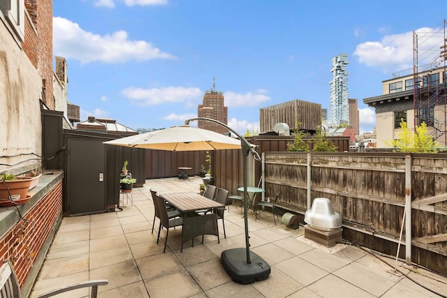 165 Hudson St Pha, Pha, New York City, NY 10013 - fenced backyard with a patio area, outdoor dining space, and a city view