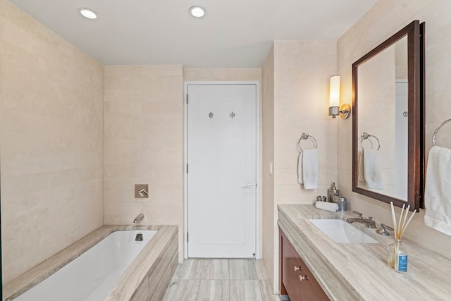 80 Riverside Blvd Unit 16-P, New York City, NY 10069 - bathroom featuring tiled bath, vanity, recessed lighting, and tile walls