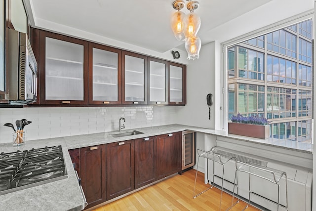 80 Riverside Blvd Unit 16-P, New York City, NY 10069 - kitchen with a sink, appliances with stainless steel finishes, beverage cooler, and decorative backsplash