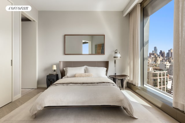 500 W 18th St Unit West9F, New York City, NY 10011 - bedroom with a skyline view and wood finished floors