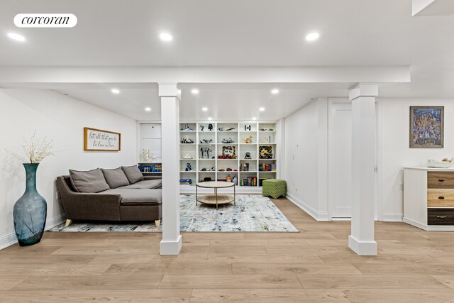 8119 Ridge Blvd, New York City, NY 11209 - living area with light wood-style floors, decorative columns, baseboards, visible vents, and recessed lighting