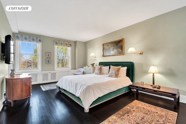 bedroom featuring visible vents and wood finished floors
