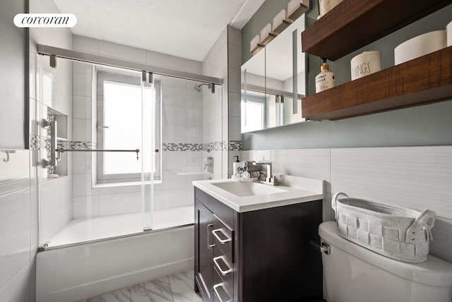 68 Bradhurst Ave Unit 6V, New York City, NY 10030 - full bathroom featuring toilet, vanity, shower / bath combination with glass door, marble finish floors, and a textured ceiling