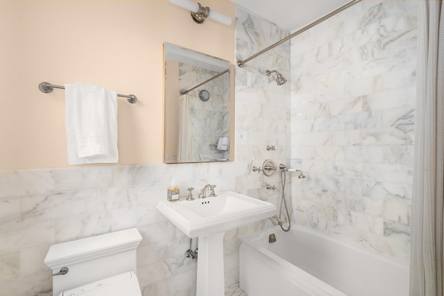 277 W End Ave Unit 9E, New York City, NY 10023 - bathroom featuring shower / bath combo with shower curtain, toilet, and tile walls