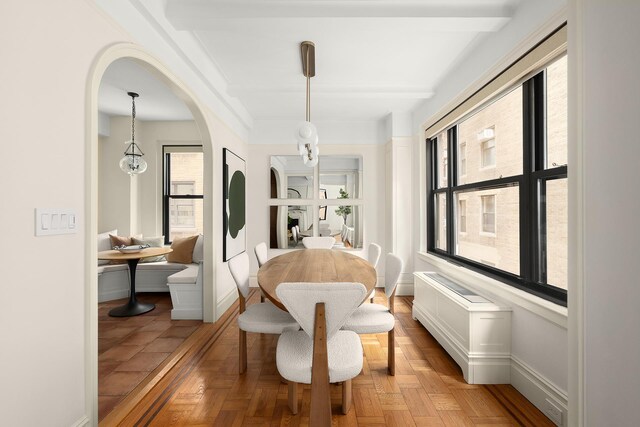 277 W End Ave Unit 9E, New York City, NY 10023 - dining area featuring arched walkways, baseboards, and beamed ceiling