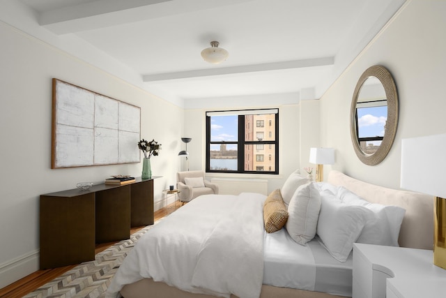 277 W End Ave Unit 9E, New York City, NY 10023 - bedroom with wood finished floors and beamed ceiling