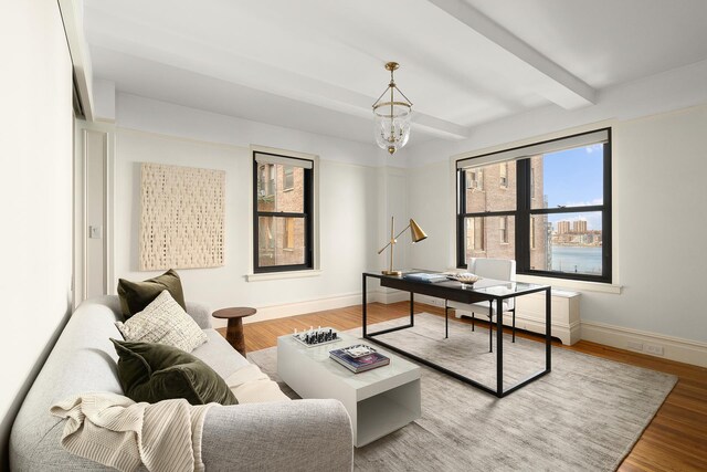 277 W End Ave Unit 9E, New York City, NY 10023 - office area with baseboards, light wood finished floors, beamed ceiling, and a chandelier