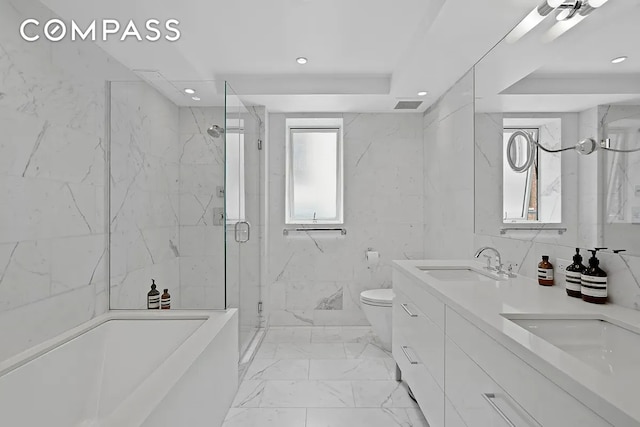 bathroom featuring visible vents, a sink, a marble finish shower, and recessed lighting