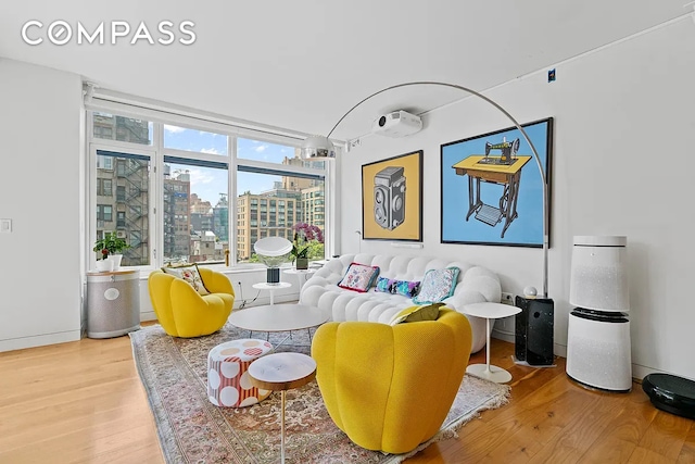 living area with a view of city and wood finished floors