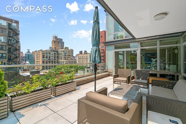 balcony with outdoor lounge area and a city view