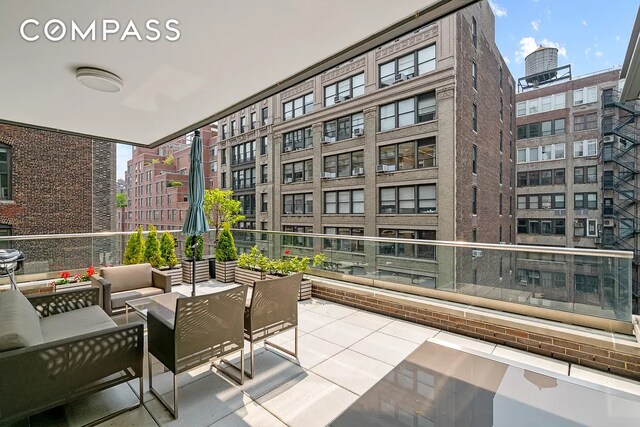 balcony featuring a city view and an outdoor living space