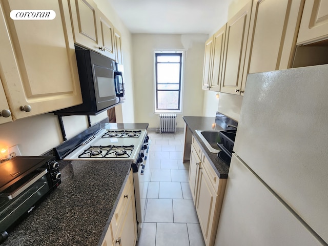 762 Brady Ave Unit 621, New York City, NY 10462 - kitchen with freestanding refrigerator, radiator, gas stove, black microwave, and a sink