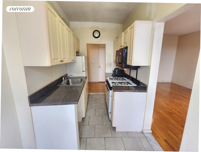 762 Brady Ave Unit 621, New York City, NY 10462 - kitchen featuring a sink, light tile patterned floors, white appliances, and white cabinetry