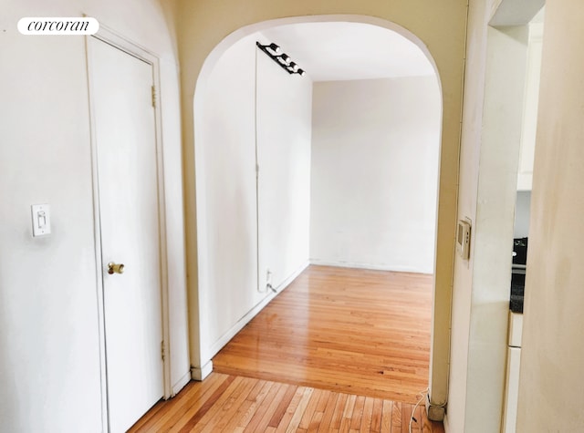762 Brady Ave Unit 621, New York City, NY 10462 - hallway featuring arched walkways and light wood-type flooring