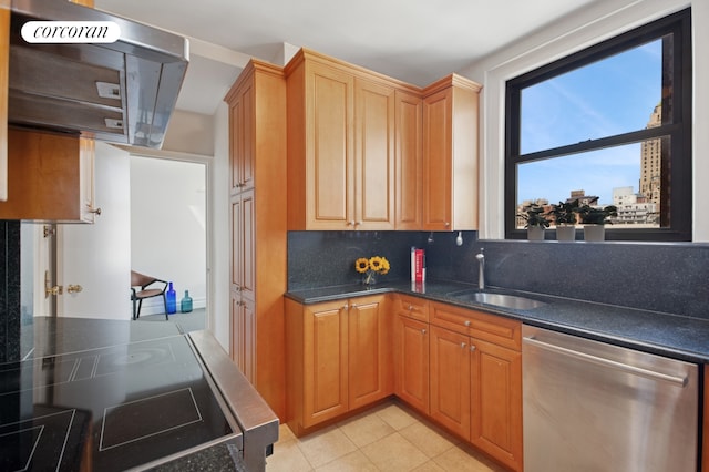 kitchen with a sink, dark stone countertops, decorative backsplash, light tile patterned floors, and stainless steel dishwasher