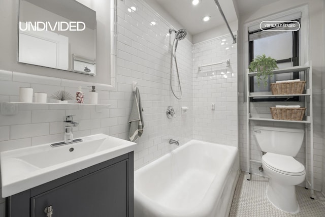 130 E 94th St Unit 2-E, New York City, NY 10128 - bathroom with tile walls, vanity, shower / bathtub combination, and recessed lighting