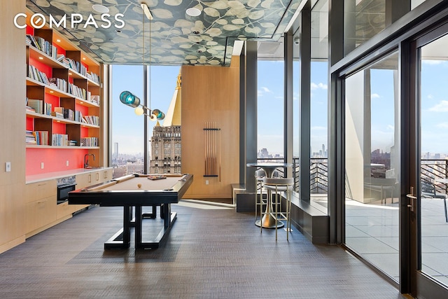 rec room featuring floor to ceiling windows, pool table, and a view of city