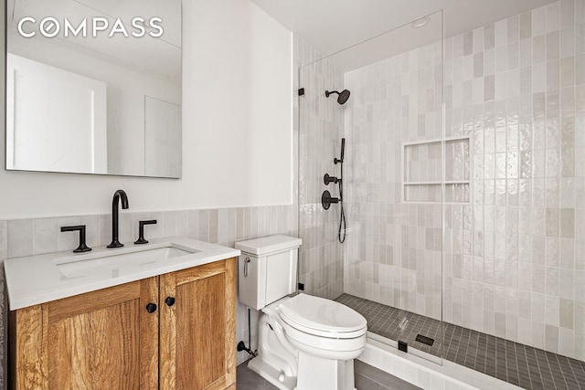 119 Henry St Unit 3, New York City, NY 11201 - bathroom with tile walls, toilet, vanity, a tile shower, and tile patterned floors