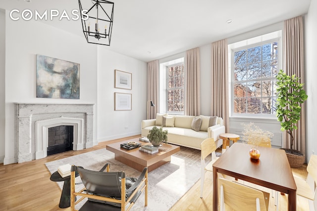 119 Henry St Unit 3, New York City, NY 11201 - living area with wood finished floors, baseboards, a chandelier, and a fireplace