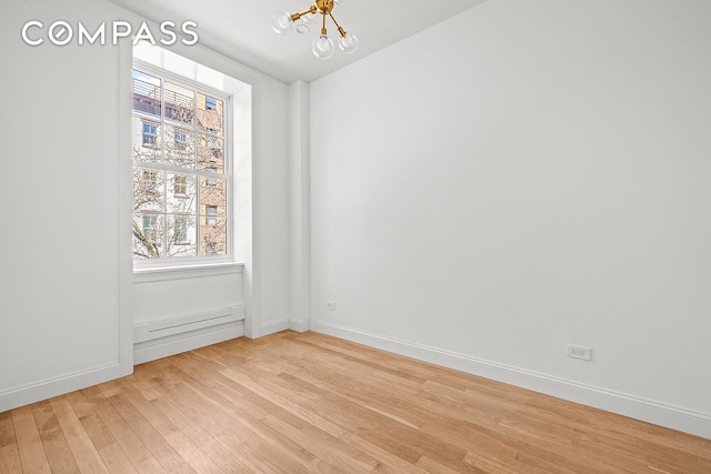 119 Henry St Unit 3, New York City, NY 11201 - unfurnished room featuring a chandelier, light wood finished floors, baseboards, and plenty of natural light
